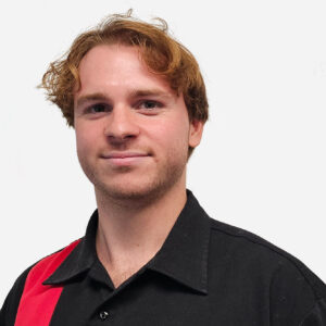 Jonny Slim, Senior Software Engineer, with short ginger hair, smiling in a black shirt.
