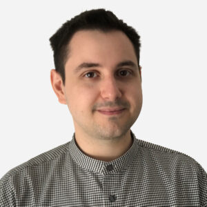 Robert Timpau, Software Engineer, with short brown hair, smiling in a checked shirt.