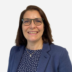 Silvia Ancelotti, Senior Software Engineer, with medium length dark brown hair and glasses, smiling in a blue blazer.